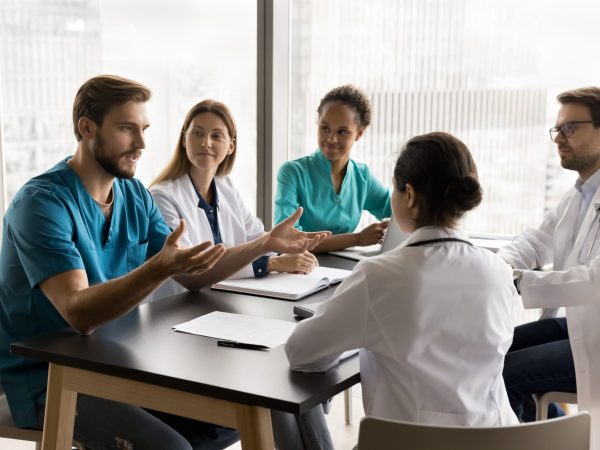 Confident,Young,Surgeon,Man,In,Blue,Medic,Uniform,Talking,To